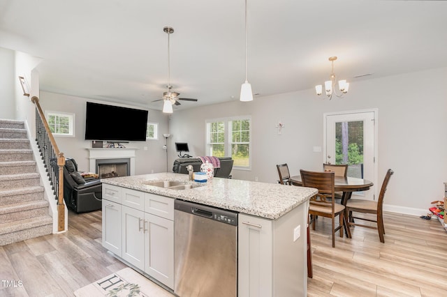 105 Forest Wood Dr, Salemburg, NC 28385 - kitchen with stainless steel dishwasher, decorative light fixtures, light wood finished floors, a fireplace, and open floor plan