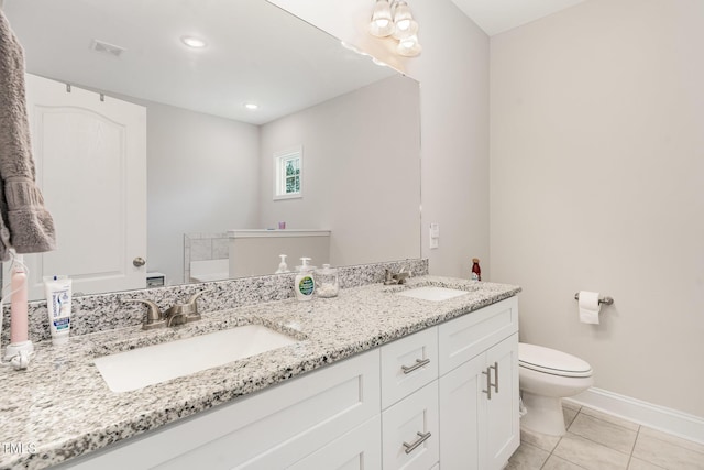 105 Forest Wood Dr, Salemburg, NC 28385 - bathroom featuring tile patterned floors, toilet, double vanity, and a sink