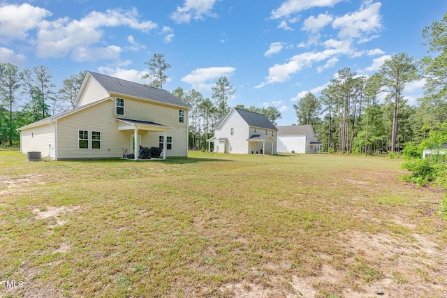 105 Forest Wood Dr, Salemburg, NC 28385 - rear view of property featuring central AC unit and a lawn