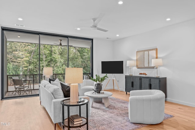 living room with wood finished floors, floor to ceiling windows, ceiling fan, baseboards, and recessed lighting