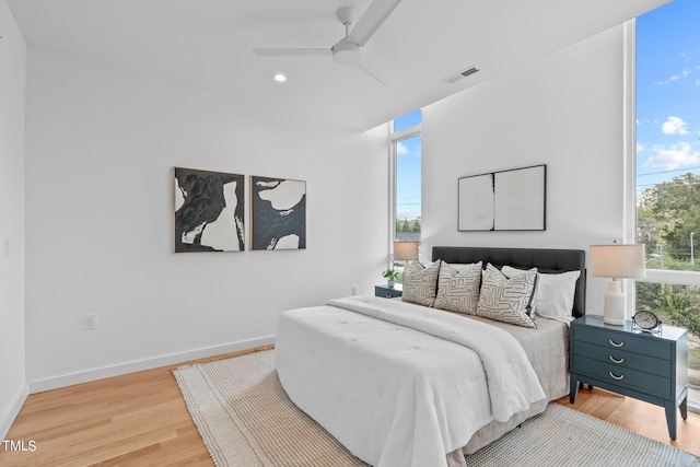 bedroom featuring ceiling fan, light wood-style flooring, baseboards, visible vents, and recessed lighting