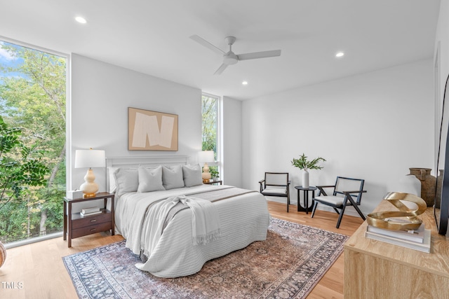bedroom featuring recessed lighting, a ceiling fan, light wood-type flooring, and floor to ceiling windows