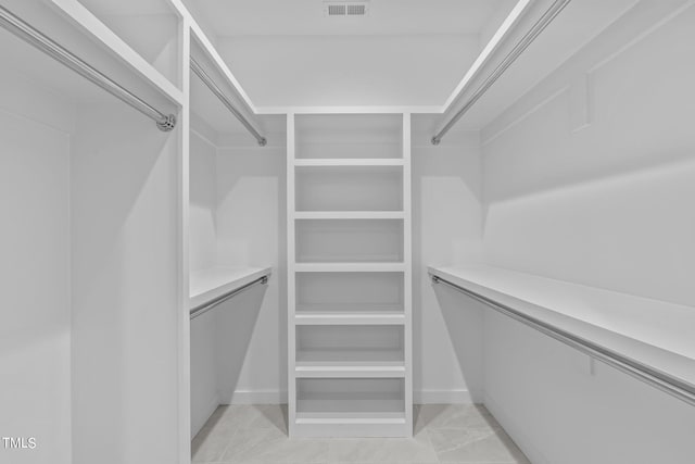 walk in closet with light tile patterned flooring