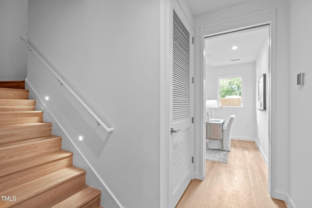 staircase with wood finished floors and baseboards