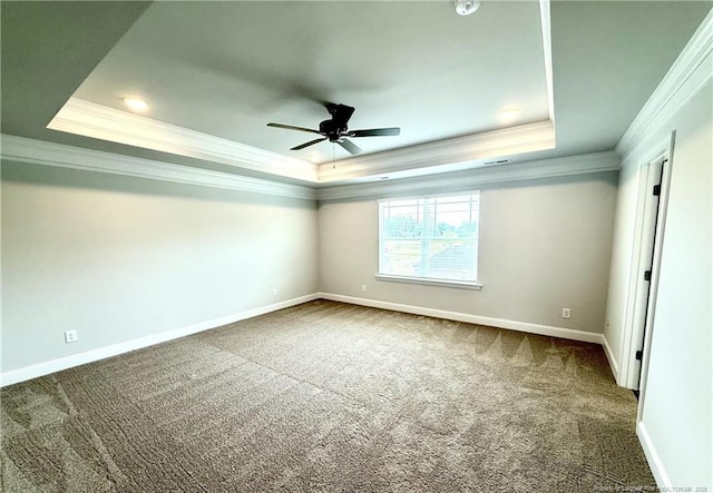 unfurnished bedroom with ornamental molding, carpet flooring, baseboards, a ceiling fan, and a tray ceiling