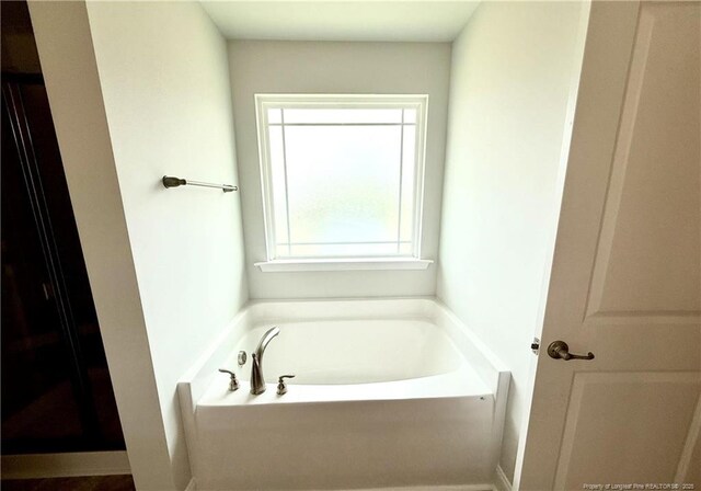 full bathroom with a garden tub