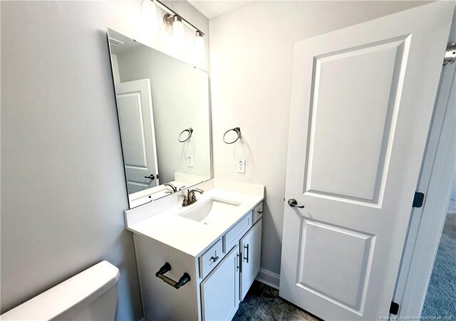 bathroom with toilet and vanity