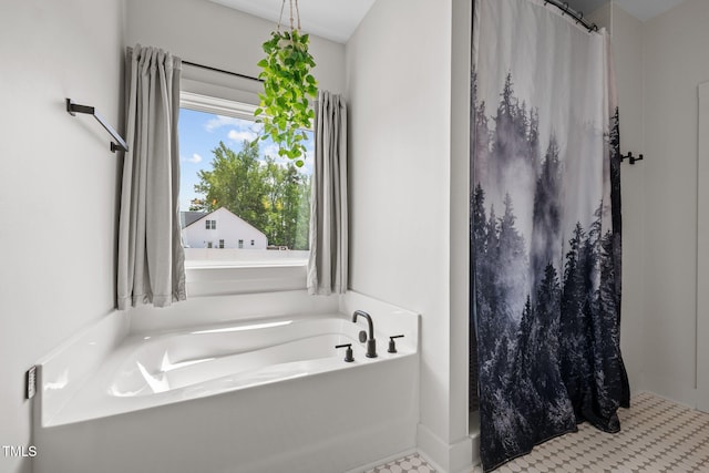 bathroom with a garden tub and curtained shower