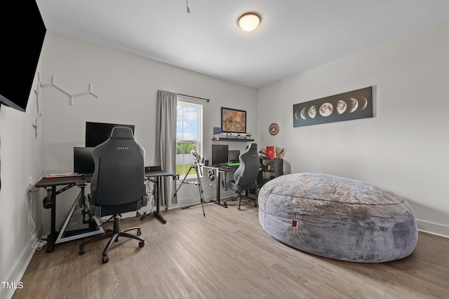 office with baseboards and wood finished floors