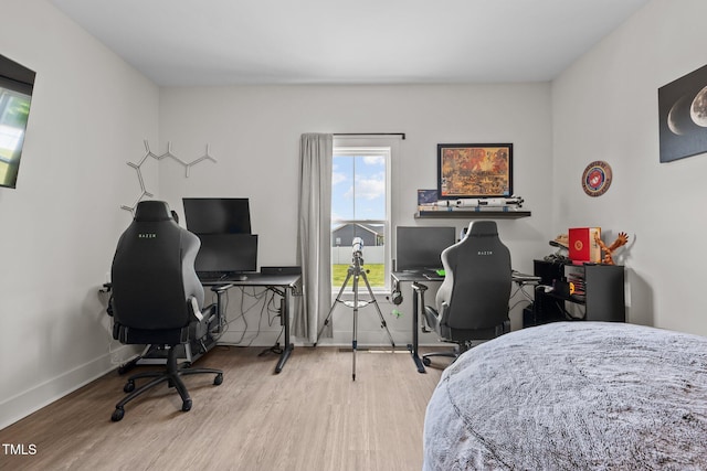 bedroom featuring baseboards and wood finished floors
