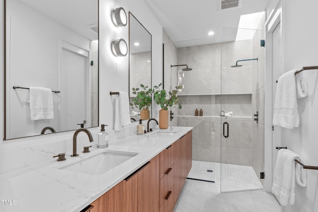 501 S Bloodworth St Unit 101, Raleigh, NC 27601 - full bathroom featuring double vanity, a shower stall, visible vents, and a sink