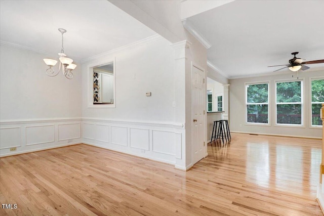 1480 Big Leaf Loop, Apex, NC 27502 - spare room featuring crown molding, light wood finished floors, a ceiling fan, a chandelier, and a wainscoted wall