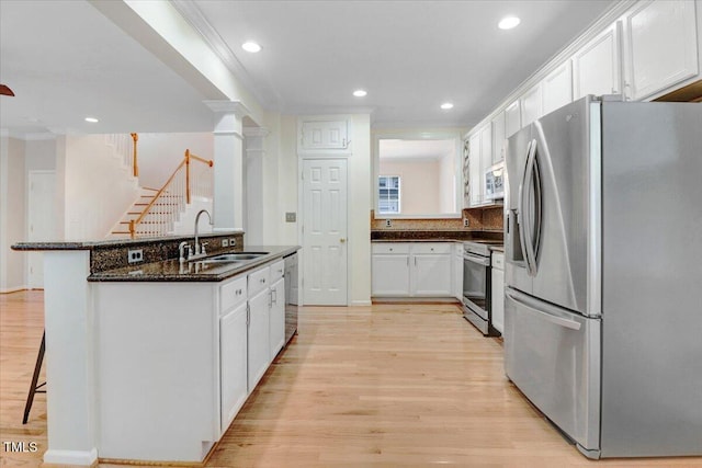 1480 Big Leaf Loop, Apex, NC 27502 - kitchen featuring stainless steel appliances, a sink, white cabinetry, light wood-style flooring, and recessed lighting