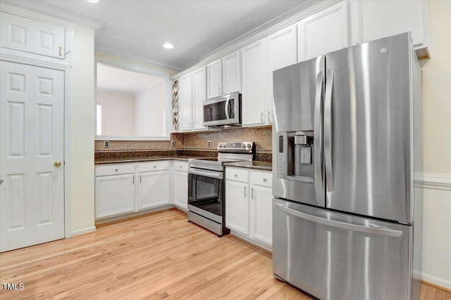 1480 Big Leaf Loop, Apex, NC 27502 - kitchen with stainless steel appliances, light wood-style floors, white cabinets, tasteful backsplash, and ornamental molding
