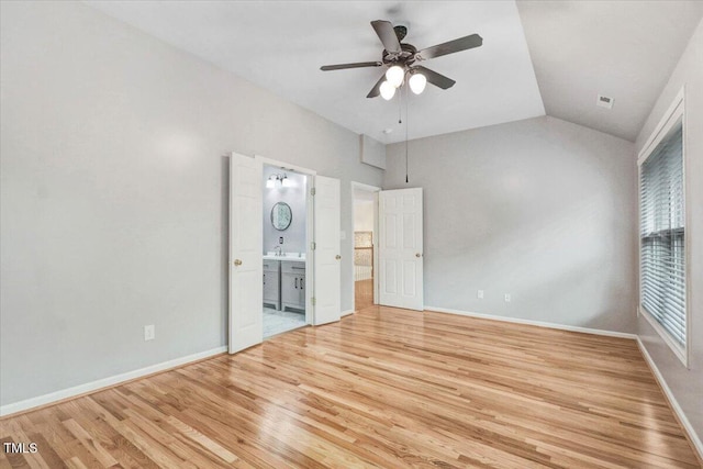 1480 Big Leaf Loop, Apex, NC 27502 - unfurnished bedroom with light wood-type flooring, connected bathroom, vaulted ceiling, baseboards, and ceiling fan