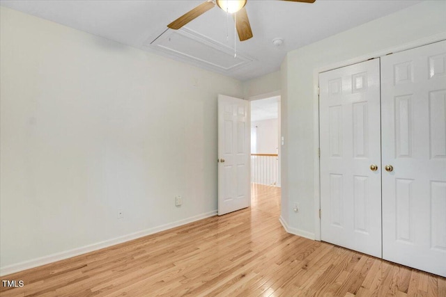 1480 Big Leaf Loop, Apex, NC 27502 - unfurnished bedroom featuring attic access, light wood-type flooring, baseboards, a closet, and a ceiling fan