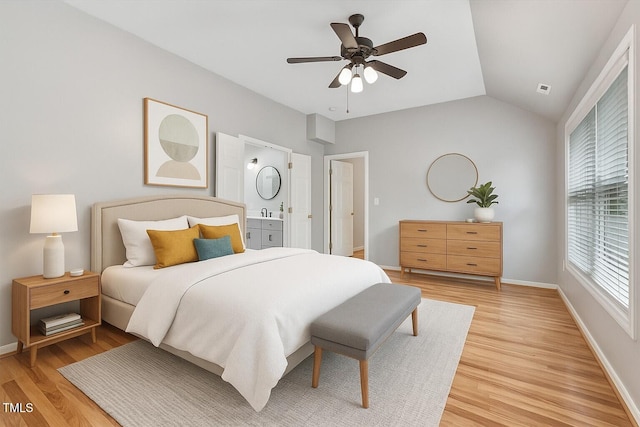 1480 Big Leaf Loop, Apex, NC 27502 - bedroom with light wood-type flooring, lofted ceiling, baseboards, ceiling fan, and connected bathroom