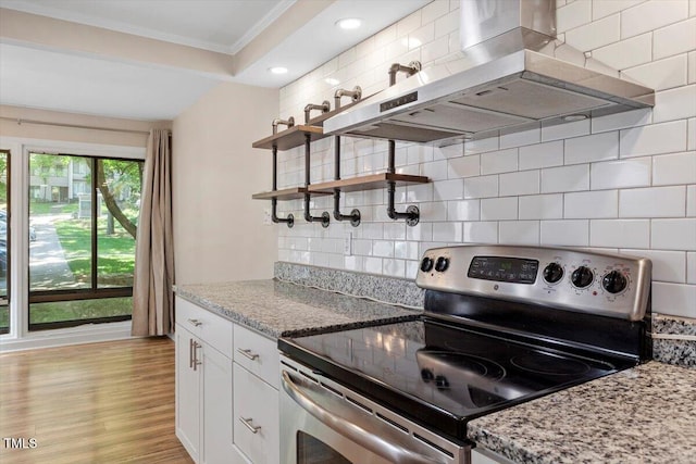kitchen featuring open shelves, ornamental molding, light wood-style floors, range hood, and stainless steel range with electric cooktop