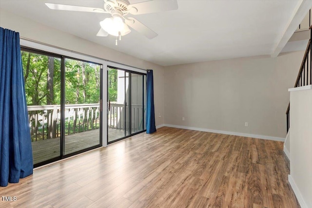 unfurnished room featuring baseboards, a ceiling fan, and wood finished floors