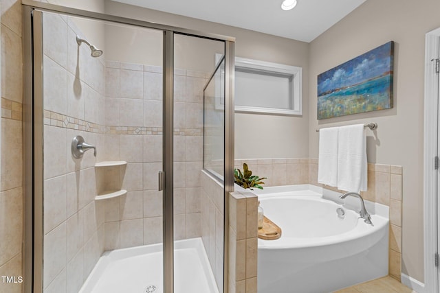 full bath featuring a garden tub, a stall shower, and tile patterned floors