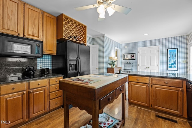 113 Denard St, Oxford, NC 27565 - kitchen featuring wallpapered walls, black appliances, ceiling fan, dark wood-style floors, and visible vents