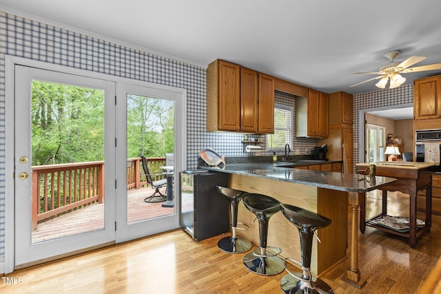 113 Denard St, Oxford, NC 27565 - kitchen featuring wallpapered walls, a kitchen breakfast bar, stainless steel oven, and a sink