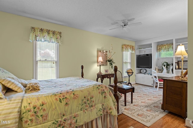 113 Denard St, Oxford, NC 27565 - bedroom with light wood finished floors, a textured ceiling, multiple windows, and a ceiling fan