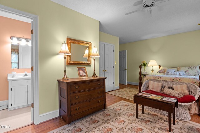 113 Denard St, Oxford, NC 27565 - bedroom featuring baseboards, ensuite bathroom, light wood-style flooring, and a sink
