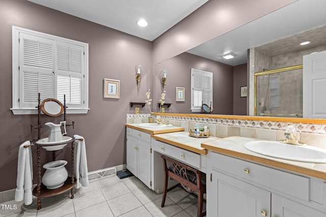113 Denard St, Oxford, NC 27565 - bathroom with tile patterned flooring, double vanity, a sink, baseboards, and a stall shower