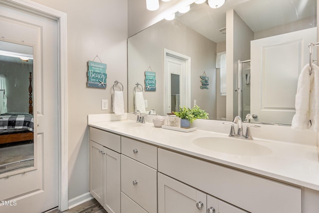 420 Cherry St, Fuquay Varina, NC 27526 - bathroom with an enclosed shower, double vanity, baseboards, and a sink