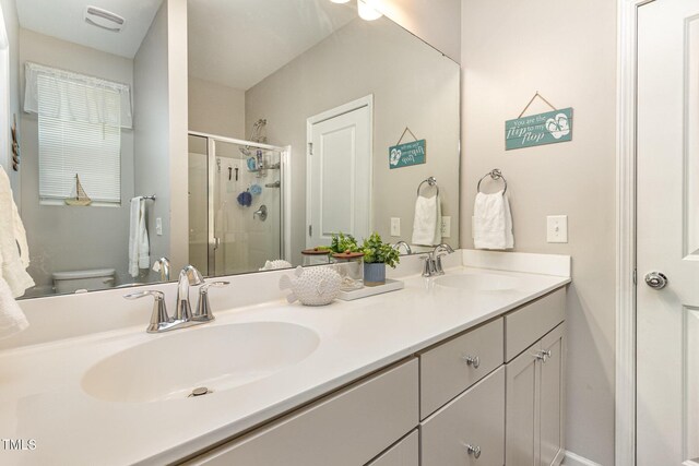 420 Cherry St, Fuquay Varina, NC 27526 - bathroom with double vanity, a sink, a stall shower, and toilet