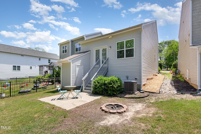 420 Cherry St, Fuquay Varina, NC 27526 - back of house with fence, central AC, an outdoor fire pit, a patio area, and a lawn