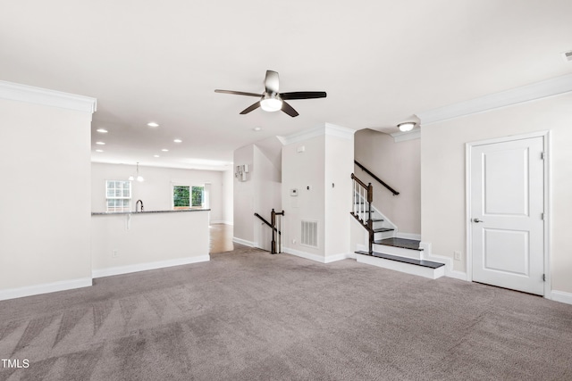1101 Boxcar Way, Apex, NC 27502 - unfurnished living room featuring ceiling fan, carpet floors, recessed lighting, baseboards, and ornamental molding