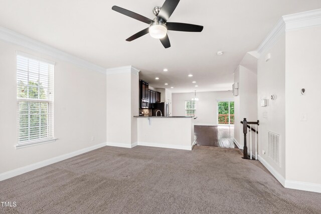 1101 Boxcar Way, Apex, NC 27502 - unfurnished living room featuring dark colored carpet, baseboards, ceiling fan, and recessed lighting