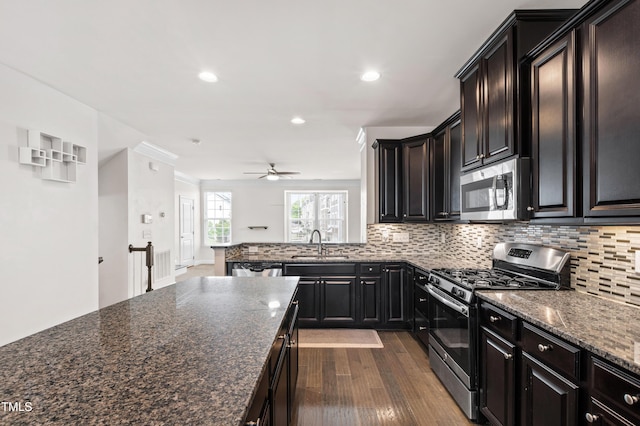 1101 Boxcar Way, Apex, NC 27502 - kitchen with stainless steel appliances, backsplash, dark wood-style flooring, recessed lighting, and a ceiling fan