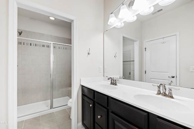 1101 Boxcar Way, Apex, NC 27502 - bathroom featuring a stall shower, toilet, double vanity, and tile patterned floors