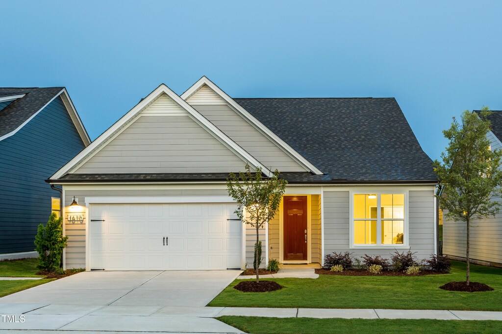 1610 Garden Park Cir, Fuquay Varina, NC 27526 - view of front of home featuring concrete driveway, a front lawn, an attached garage, and roof with shingles