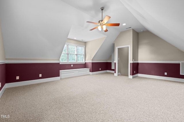 additional living space with carpet floors, a ceiling fan, visible vents, and lofted ceiling