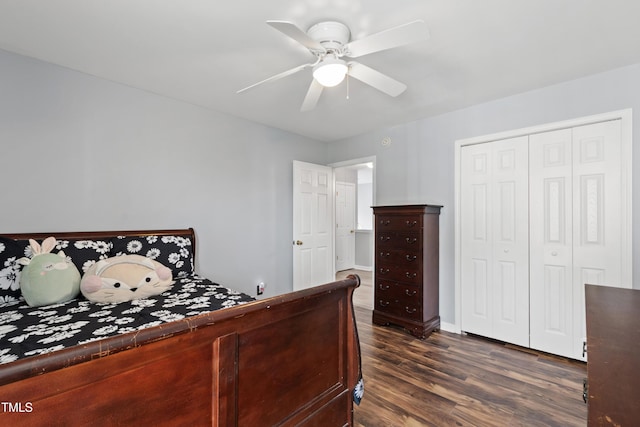 bedroom with dark wood-type flooring, a closet, ceiling fan, and baseboards