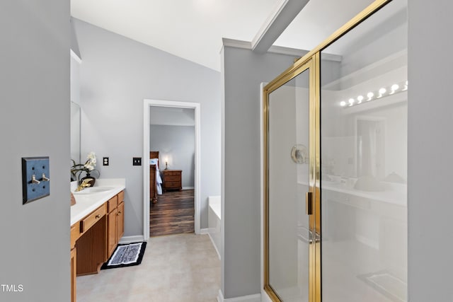 full bathroom with a stall shower, vanity, a garden tub, and ensuite bathroom