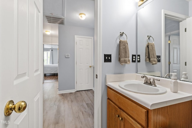 bathroom with wood finished floors and vanity
