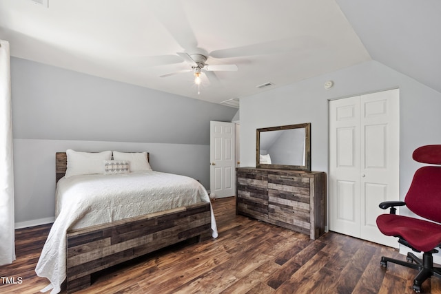 bedroom with lofted ceiling, wood finished floors, a ceiling fan, and a closet