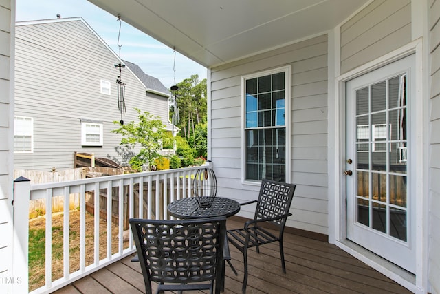 wooden terrace with outdoor dining space