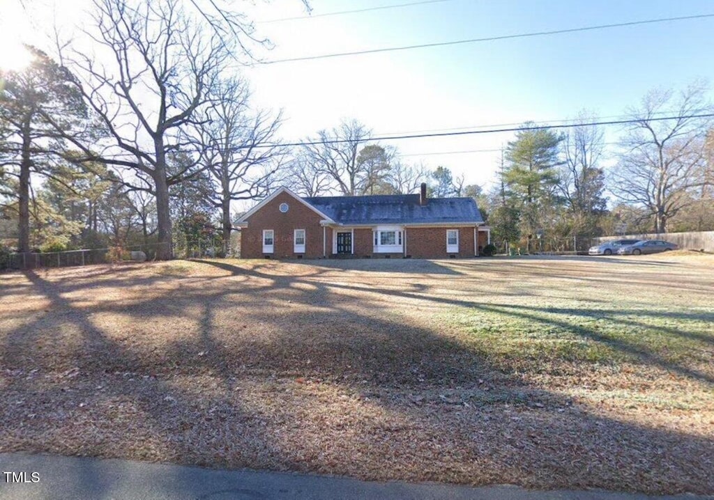 119 Watson St, Enfield, NC 27823 - view of front of home featuring fence, a front lawn, and brick siding