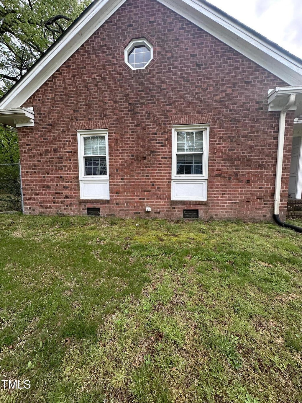 119 Watson St, Enfield, NC 27823 - view of side of home with a yard, brick siding, and crawl space