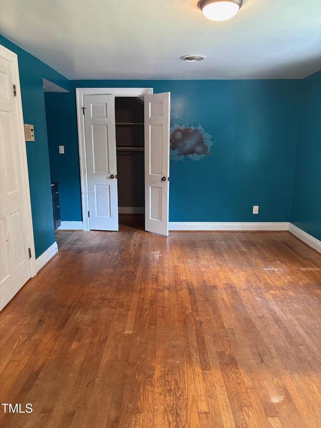 119 Watson St, Enfield, NC 27823 - unfurnished bedroom featuring hardwood / wood-style flooring and a closet
