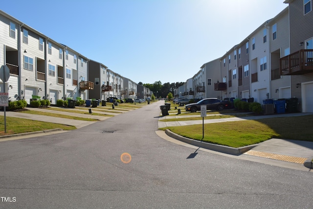 view of street with traffic signs, curbs, and a residential view