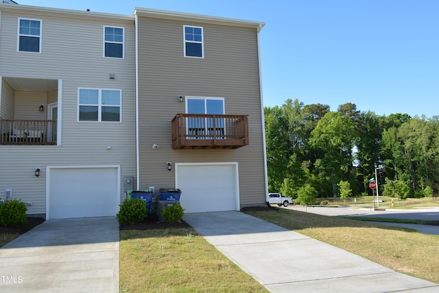 exterior space featuring a lawn, an attached garage, and driveway