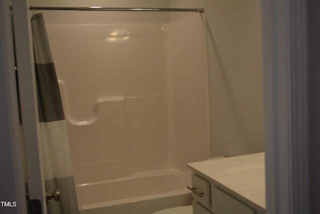 bathroom featuring shower / bath combo with shower curtain, toilet, and vanity