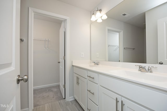 2401 Laurel Valley Way, Raleigh, NC 27604 - full bath featuring a walk in closet, double vanity, and baseboards